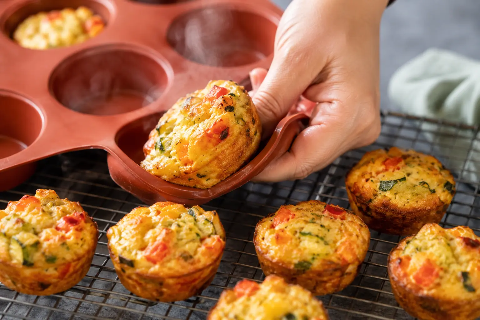 Muffins tofu-légumes dorés démoulés sur une grille de refroidissement